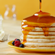 Stack of pancakes covered in syrup
